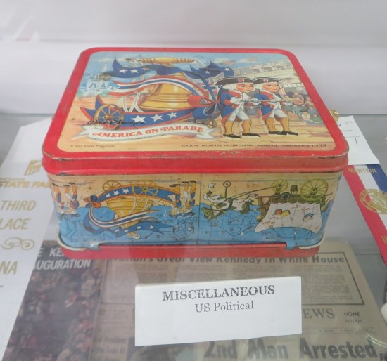 Old lunchbox with two kiddie patriots towing a Liberty Bell in a July 4th parade.