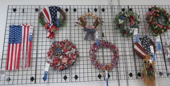 America-themed wreaths hanging on a wall rack.