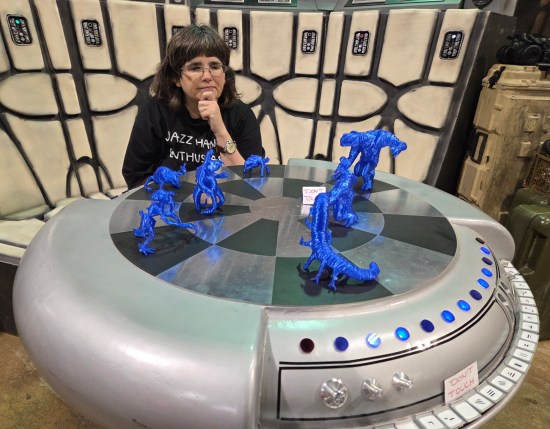 Anne at Dejarik table with blue figurines.
