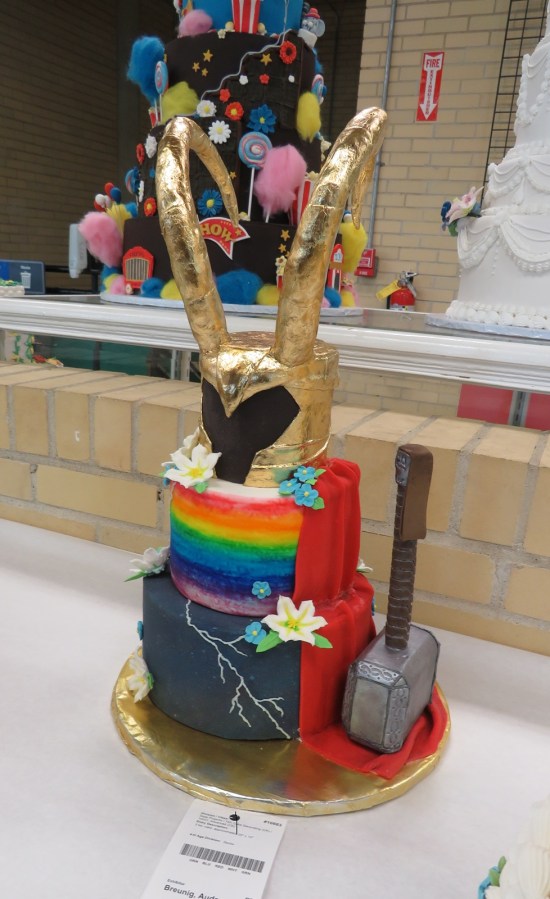 Cake festooned with Loki's helmet, Mjolnir, lightning, and the Bifrost Bridge.