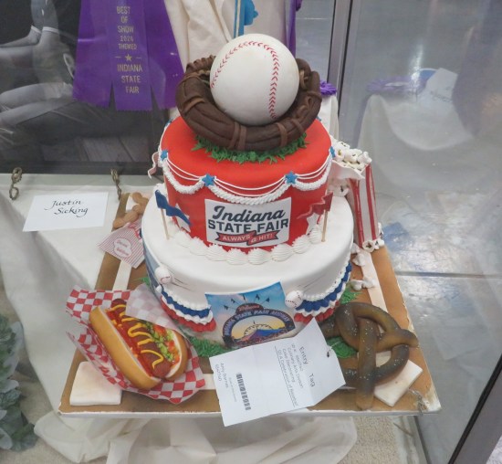 2-layer cake with icing baseball and mitt on top.
