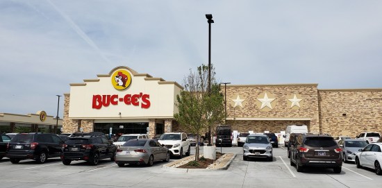 Buc-ee's beige exterior, the size of a department store but with a cartoon beaver's head above the logo.