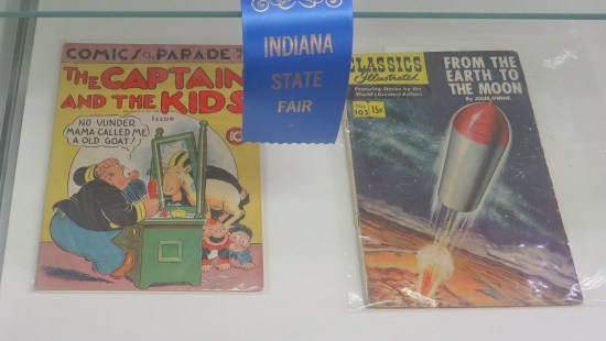 two old comics in vitrine, refer to caption.