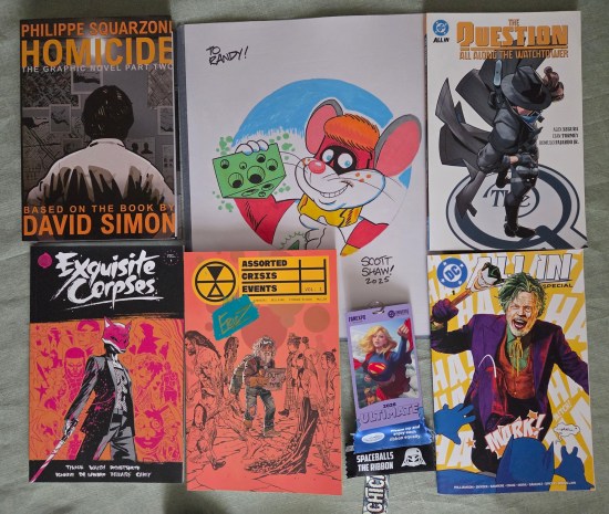 five publications and a Little Cheese sketch arranged on a table.