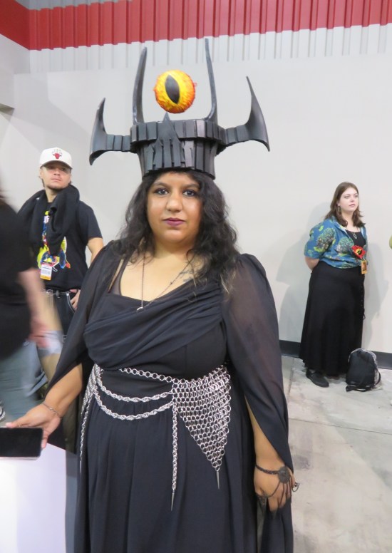 Cosplayer dressed as Sauron's tower in Mordor, with red and yellow eye globe in her spired hat.