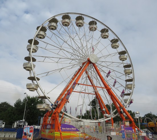 Large Ferris wheel that has gondolas that each hold 4-6 instead of just two-person seats.