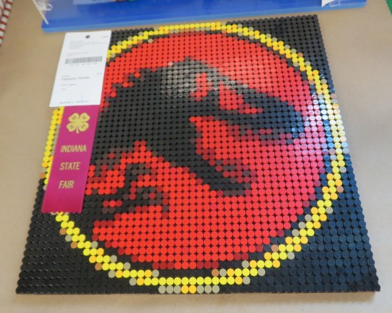 Jurassic Park logo flat on table, done in beads.