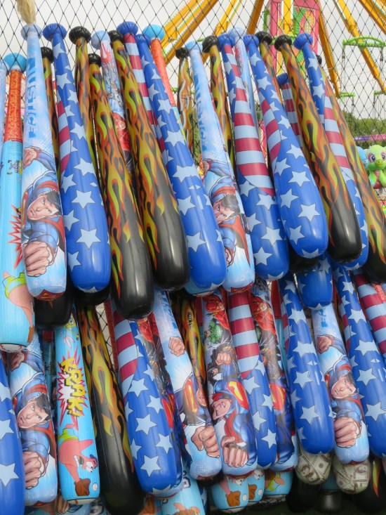 Two rows of inflatable bats hung outdoors.
