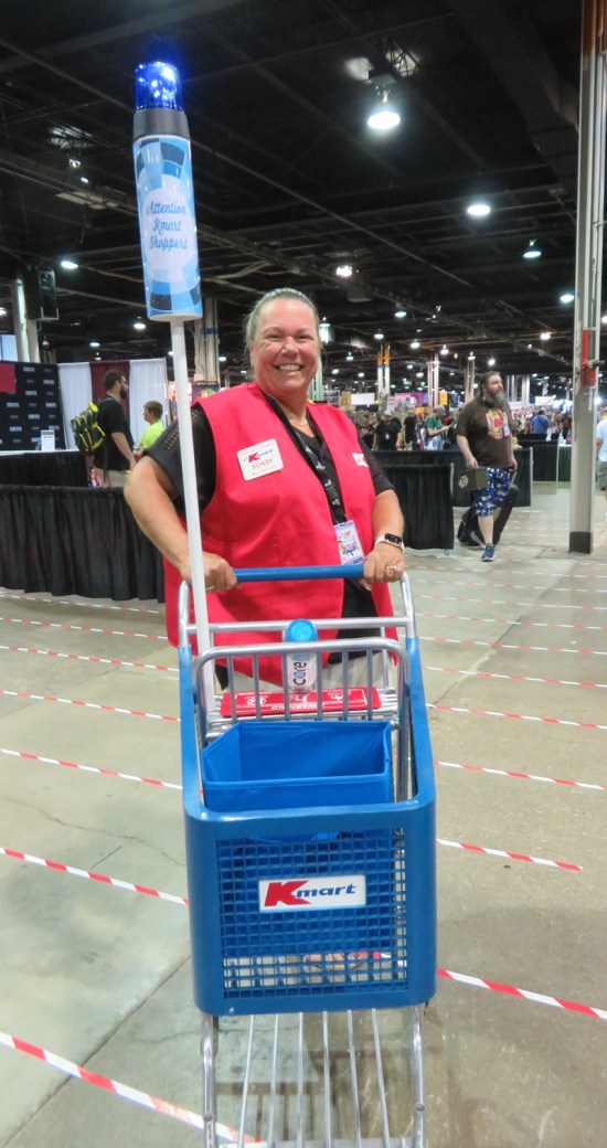 1980s Kmart employee costume with cart with blue light on a pole.