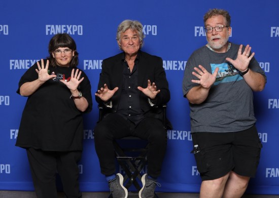 Us doing jazz hands with Kurt Russell, who's wearing all black, seated, doing light jazz hands and smiling like a congenial movie star.