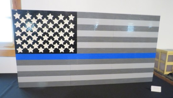 Black and white US flag with a horizontal blue stripe through the  middle, all made of Lego.