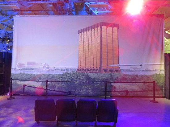 Large wall hanging of a future cityscape with only one tall building sticking up above the rest.