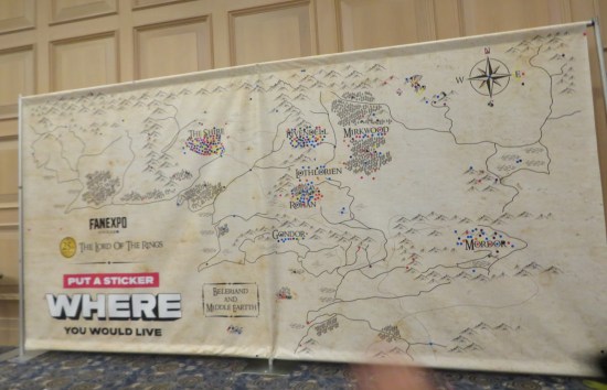 Wall-sized Middle Earth map with tiny circle stickers clustered around the major locations.