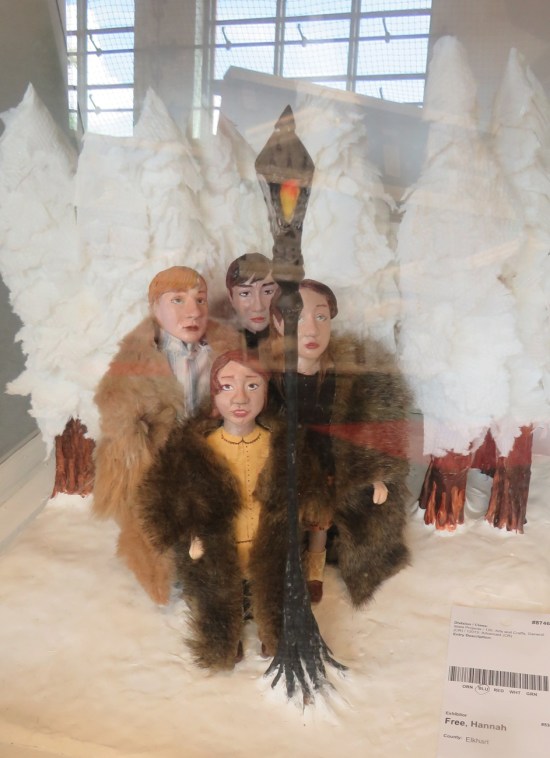 Sculpture of the four Narnia kids gathered around a lamppost in the snow.