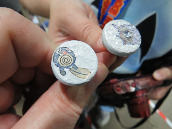 Closeups of Hershey's Kisses with Pokemon art on the bottom.