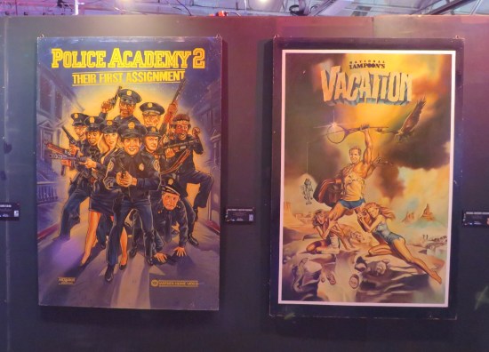 Movie posters for "Police Academy 2" and "National Lampoon's Vacation".
