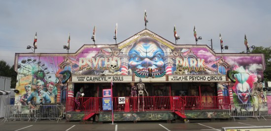 Spooky fun house called Psycho Park touting pretend movies called "Carnevil of Souls" and "The Psycho Circus".