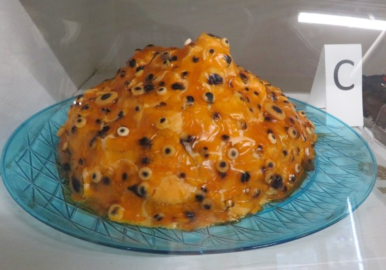 Orange pile of jellied cake or something, covered in googly eyes.