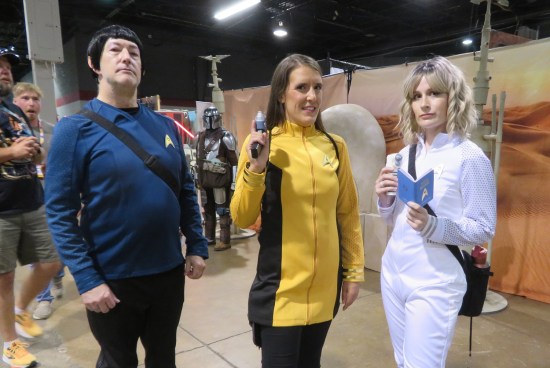 three Star Trek cosplayers, refer to caption