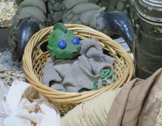 Closeup of baby Rhodian doll in a diorama.