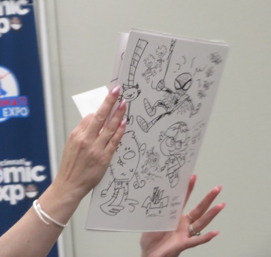 Paper with doodles all over it, most prominently a cartoonish Spider-Man.