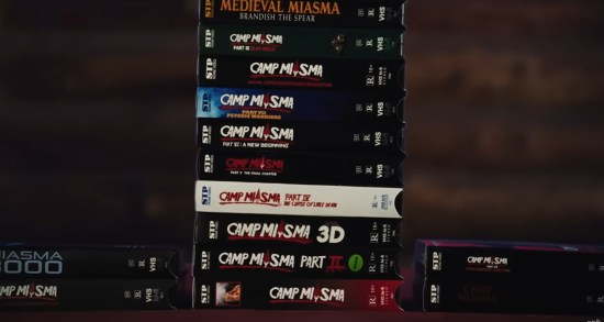 Stacks of fake VHS films from the fictional Camp Miasma video rental empire.
