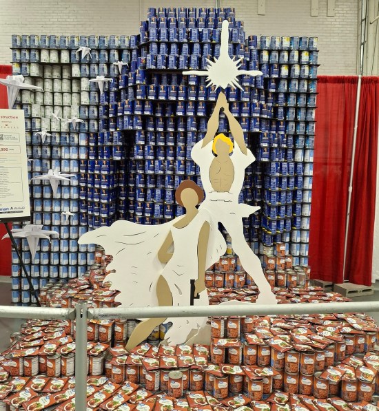 Paper Luke and Leia standees and paper spaceships flying in front of a canned version of the original Star Wars poster backdrop
