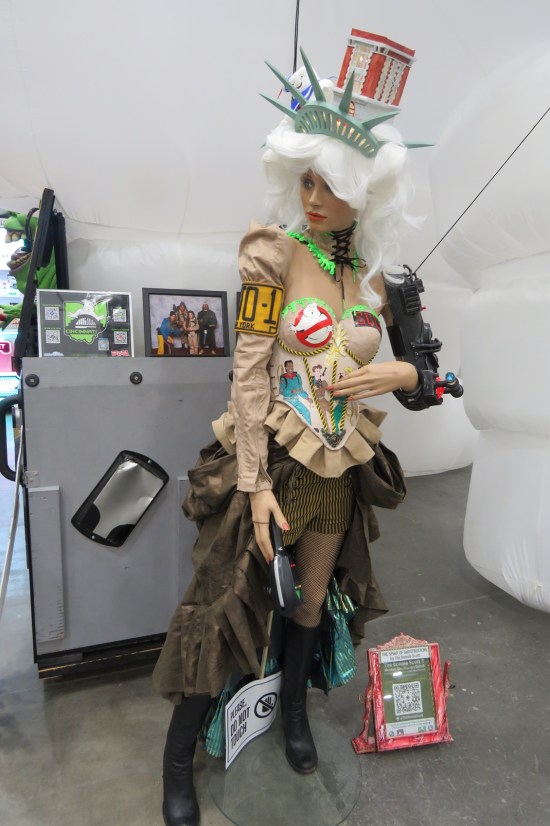 mannequin covered in various Ghostbuster accessories and collectibles.