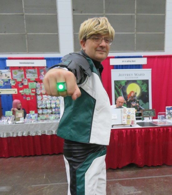 Guy Gardner cosplayer aims his Green Lantern ring at us.