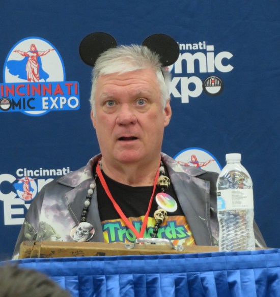 Scott Beaderstadt on a panel, wearing Mickey Mouse ears.