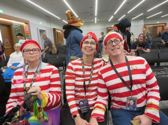 Three Waldo cosplayers, each with a different theme, including a Star Trek variant.