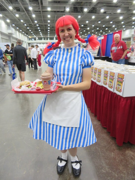 costume of Wendy's mascot carrying a tray with a Dave's Single, fries and Frosty.
