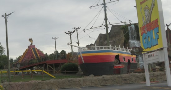 Lost Treasure Golf course with decor including ziggurat with a cobra statue on top, and a rainbow-colored pirate ship.
