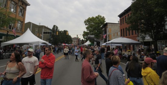 Crowds milling around a small-city festival street