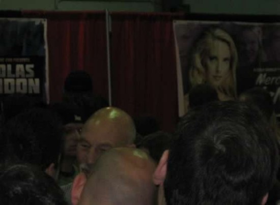 Patrick Stewart in a poorly lit convention center, mobbed by geeks.