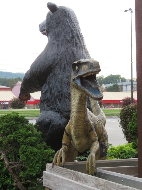 Raptor statue behind a black bear statue.