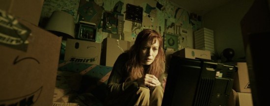 Redhead woman sits in her house, despairing amid tons of weird packages.