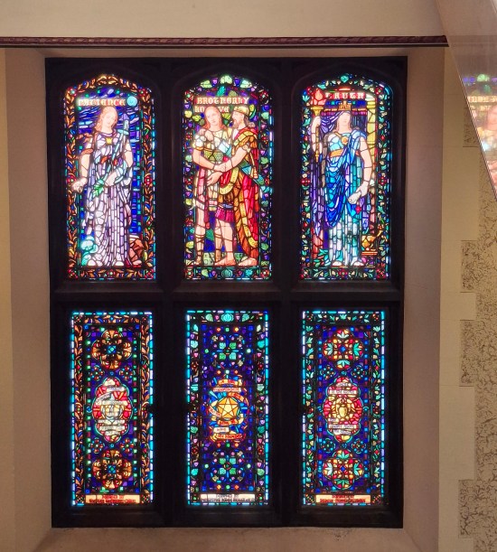 Six stained glass windows in a Catholic cathedral, vertically rectangular.