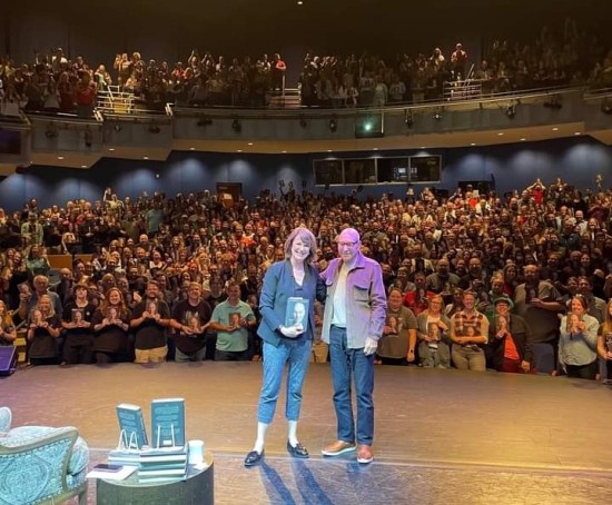 Stewart with host and audience.