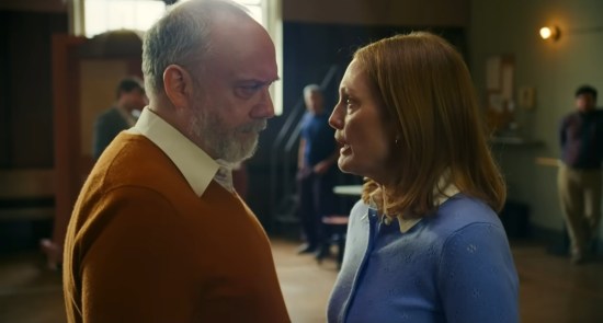Angry theater director glowers at a meek redhead actress.